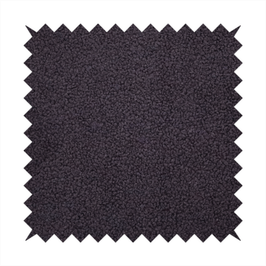 A textured dark plum or deep charcoal purple bouclé upholstery fabric.