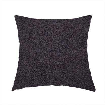 The fabric used to create this handmade cushion is a textured dark plum or deep charcoal purple bouclé upholstery fabric.