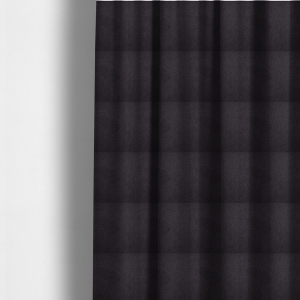 The fabric used to create these made-to-measure curtains is a textured dark plum or deep charcoal purple bouclé upholstery fabric.