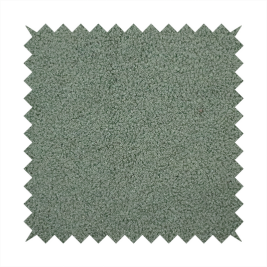A textured sage green or muted jade bouclé upholstery fabric.