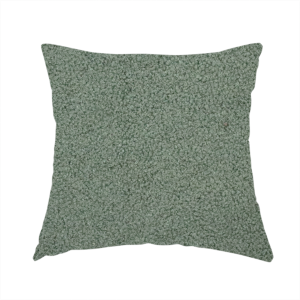 the fabric used to create this handmade cushion is a textured sage green or muted jade bouclé upholstery fabric.