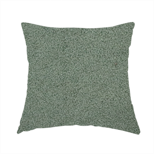 the fabric used to create this handmade cushion is a textured sage green or muted jade bouclé upholstery fabric.