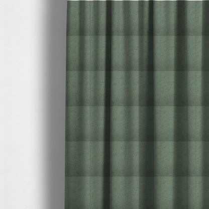 The fabric used to create these made-to-measure curtains is a textured sage green or muted jade bouclé upholstery fabric.