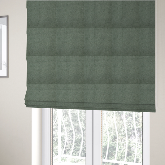 The fabric used to create these Roman blinds is a textured sage green or muted jade bouclé upholstery fabric.