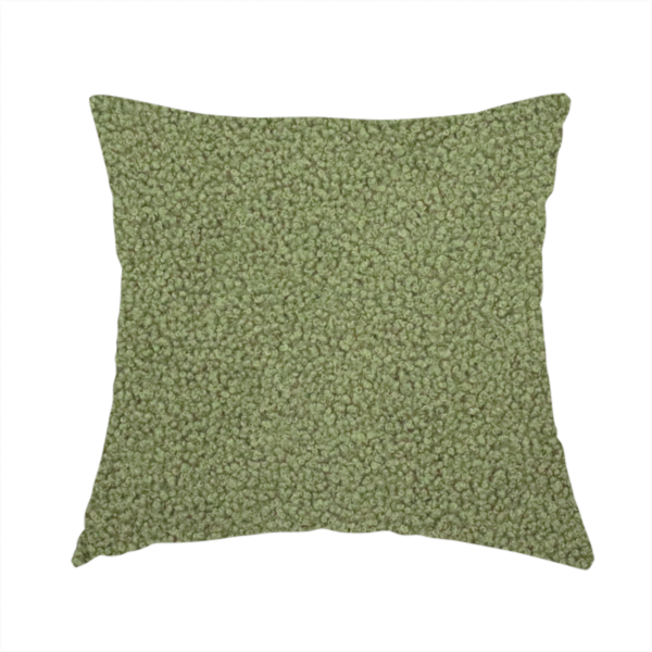The fabric used to create this handmade cushion is a dense, tightly looped, and pebbled surface characteristic of heavy wool or fleece, with subtle variations in light and shadow highlighting its nappy, tactile pile.