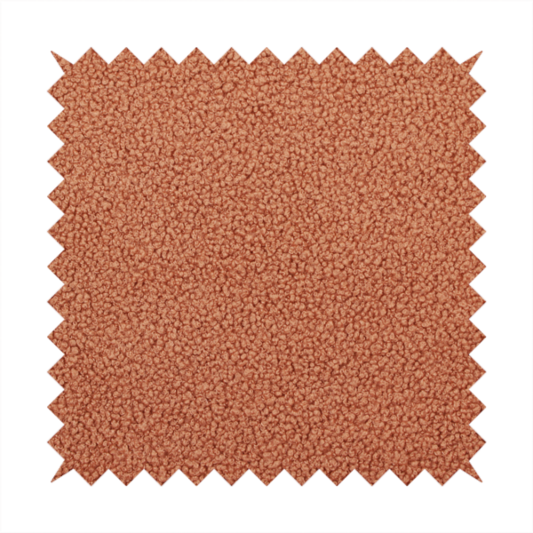 A terracotta or rust-orange boucle fabric texture.