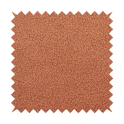 A terracotta or rust-orange boucle fabric texture.