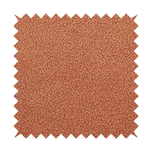 A terracotta or rust-orange boucle fabric texture.