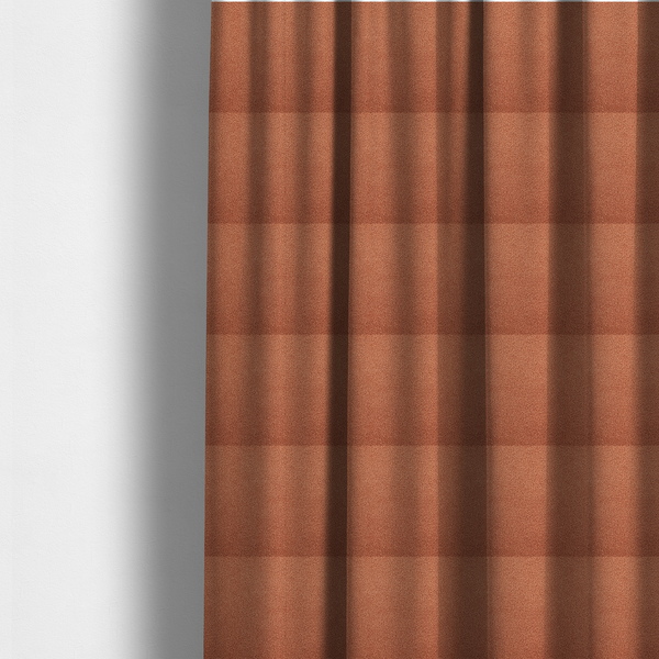 The fabric used to create these made-to-measure curtains is a terracotta or rust-orange boucle fabric texture.