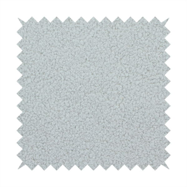 A light grey or pale ice-blue boucle fabric texture.