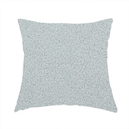 the fabric used to create this handmade cushion is a light grey or pale ice-blue boucle fabric texture.