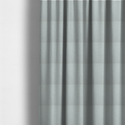 The fabric used to create these made-to-measure curtains is a light grey or pale ice-blue boucle fabric texture.