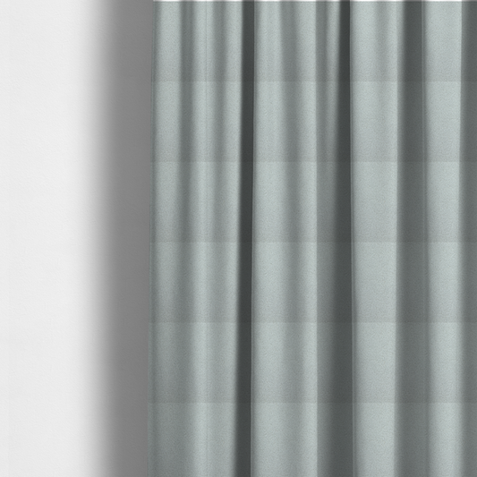 The fabric used to create these made-to-measure curtains is a light grey or pale ice-blue boucle fabric texture.