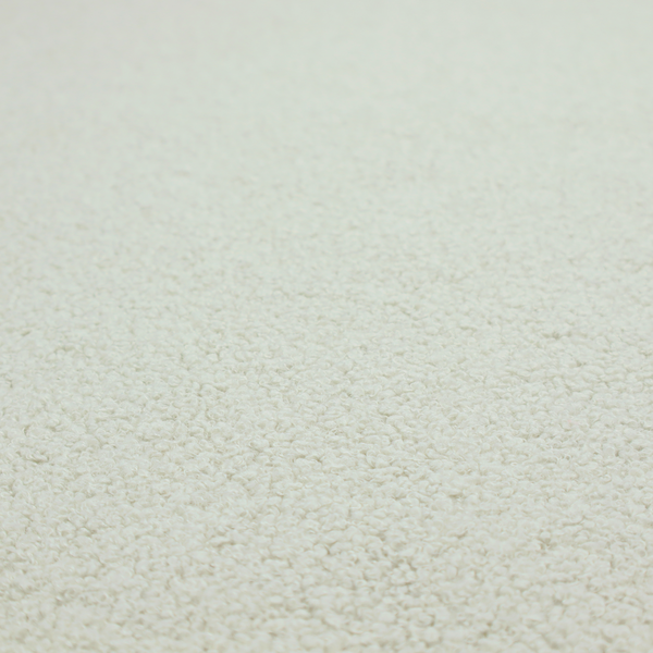 A cream or off-white boucle fabric texture.
