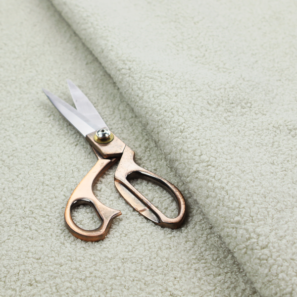 A cream or off-white boucle fabric texture.