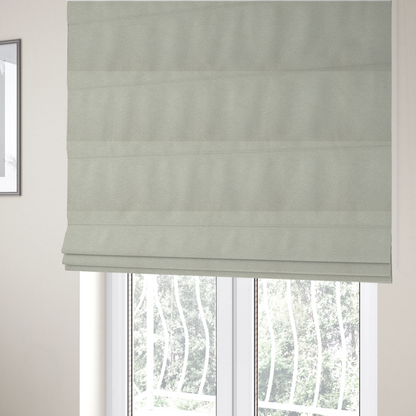 the fabric used to create these Roman blinds is a cream or off-white boucle fabric texture.