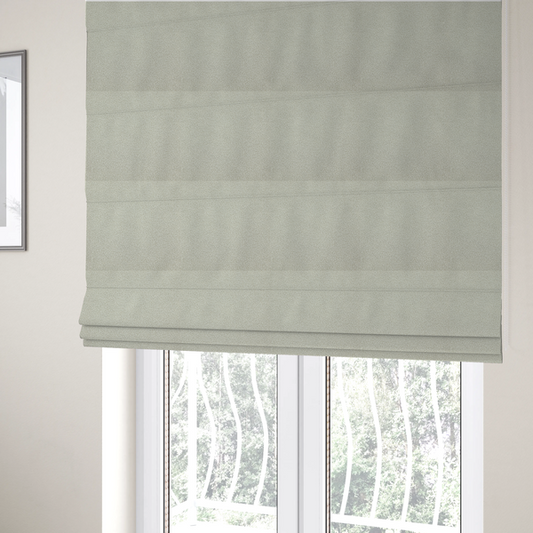 the fabric used to create these Roman blinds is a cream or off-white boucle fabric texture.