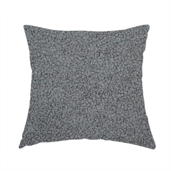 The fabric used to create this handmade cushion is a charcoal or slate grey boucle fabric texture.