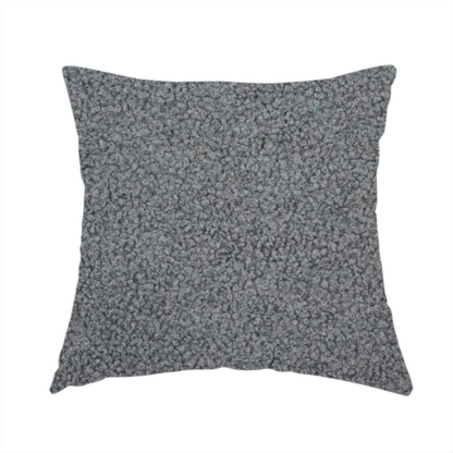 The fabric used to create this handmade cushion is a charcoal or slate grey boucle fabric texture.
