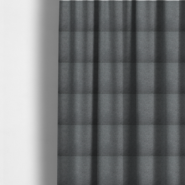 The fabric used to create these made-to-measure curtains is a charcoal or slate grey boucle fabric texture.