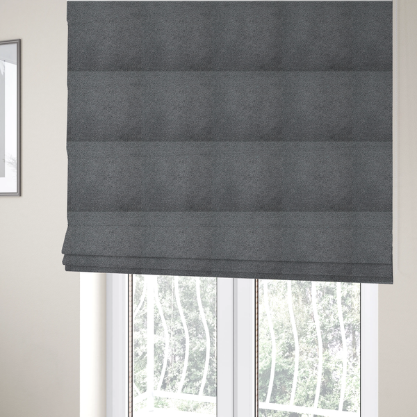 The fabric used to create these Roman blinds is a charcoal or slate grey boucle fabric texture.
