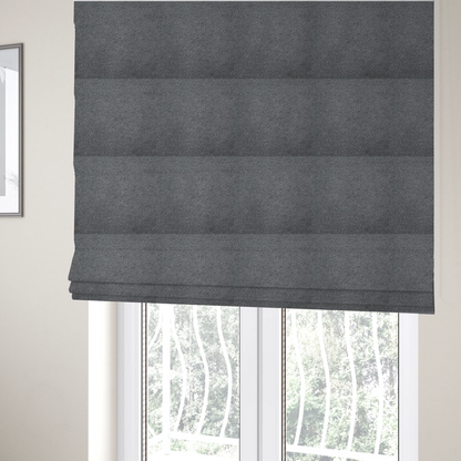 The fabric used to create these Roman blinds is a charcoal or slate grey boucle fabric texture.