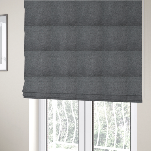 The fabric used to create these Roman blinds is a charcoal or slate grey boucle fabric texture.