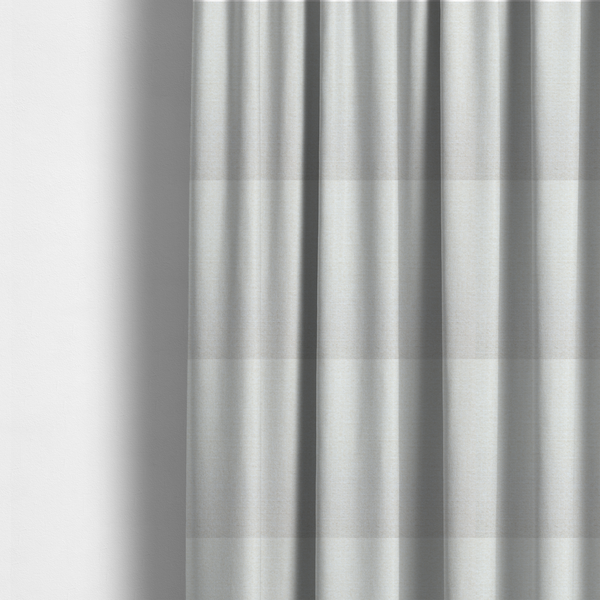 The fabric used to create these made-to-measure curtains is a off-white, finely textured woven upholstery fabric.