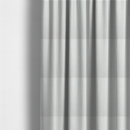 The fabric used to create these made-to-measure curtains is a off-white, finely textured woven upholstery fabric.
