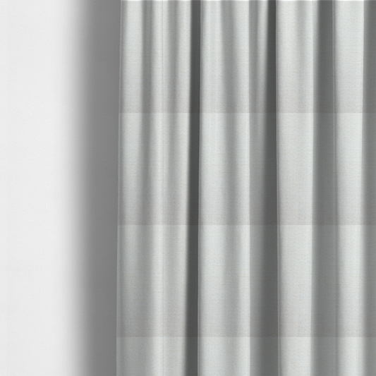 The fabric used to create these made-to-measure curtains is a off-white, finely textured woven upholstery fabric.