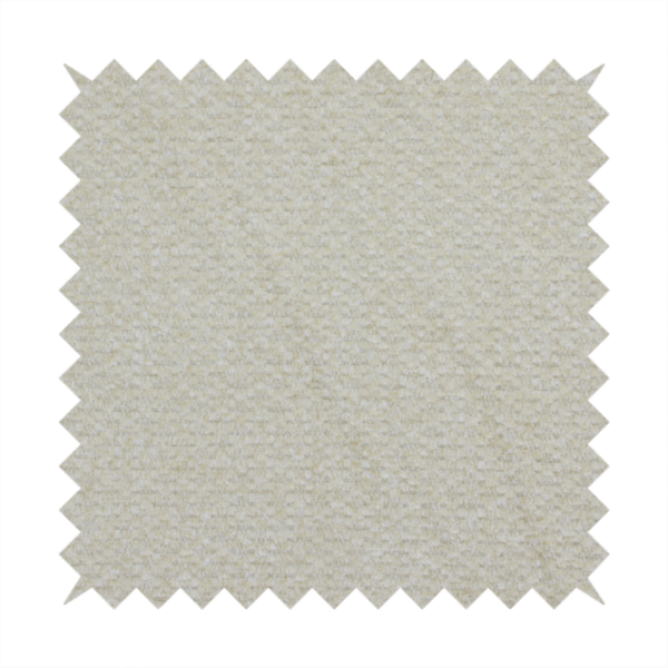 A cream-coloured, textured upholstery fabric.