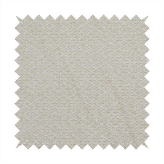 A cream-coloured, textured upholstery fabric.