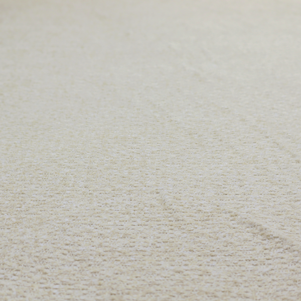 A cream-coloured, textured upholstery fabric.