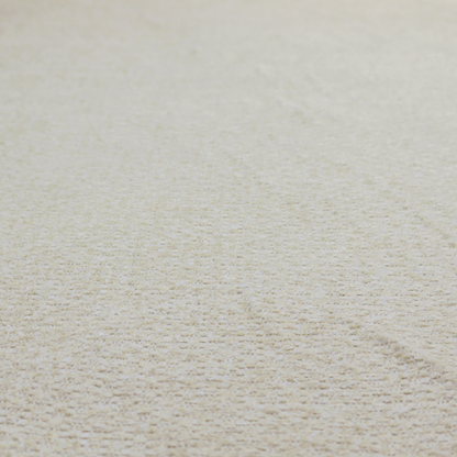 A cream-coloured, textured upholstery fabric.