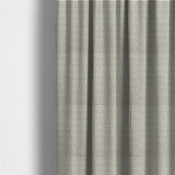 The fabric used to create these made-to-measure curtains is a cream-coloured, textured upholstery fabric.