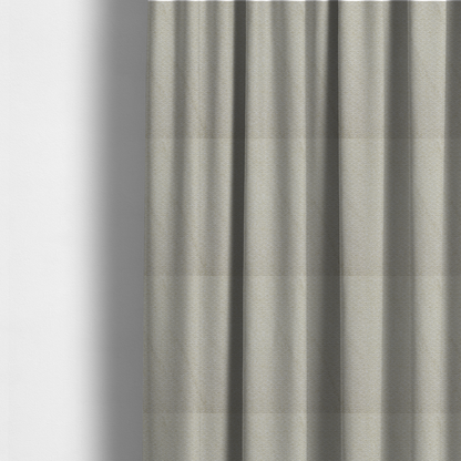 The fabric used to create these made-to-measure curtains is a cream-coloured, textured upholstery fabric.