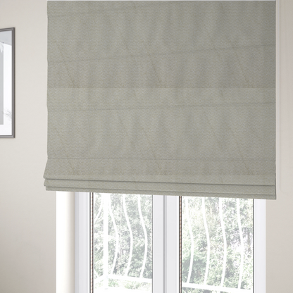 The fabric used to create these Roman blinds is a cream-coloured, textured upholstery fabric.