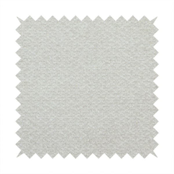 A swatch of light grey, textured upholstery fabric.