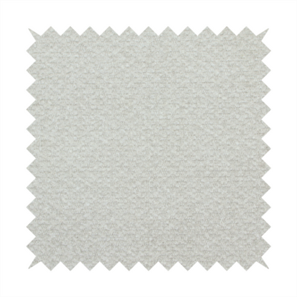 A swatch of light grey, textured upholstery fabric.
