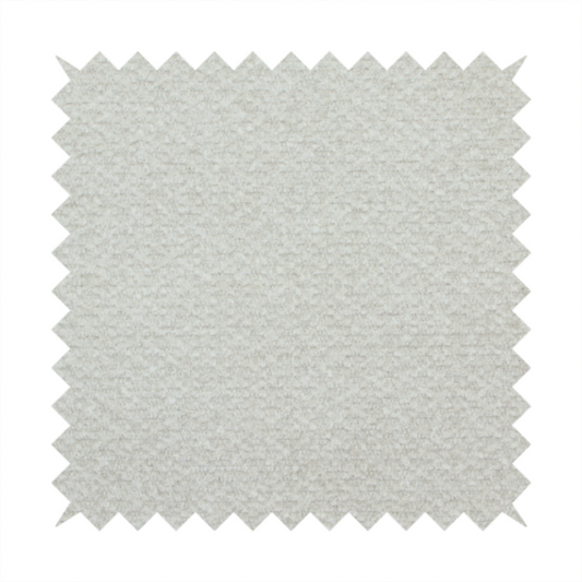 A swatch of light grey, textured upholstery fabric.