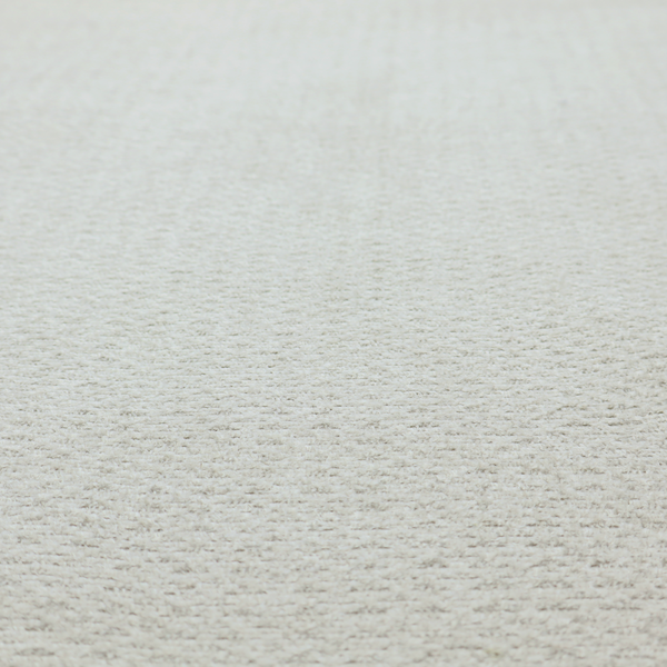 A swatch of light grey, textured upholstery fabric.