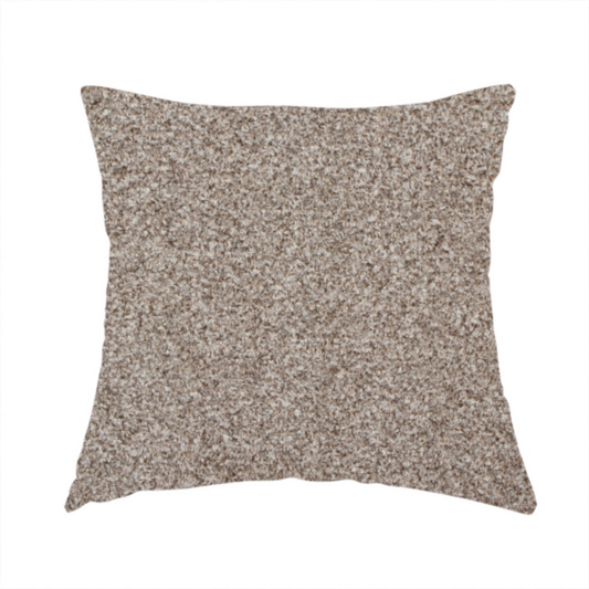 The fabric used to create this handmade cushion is a swatch of taupe, heavily textured upholstery fabric.