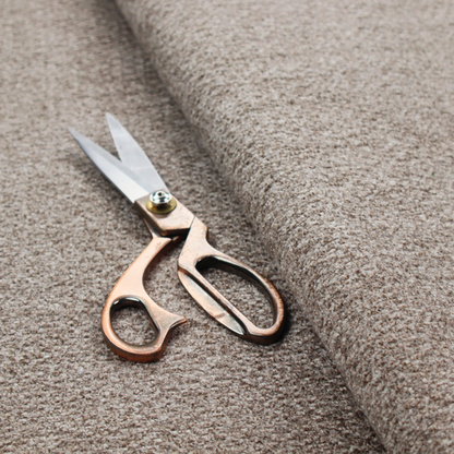 A swatch of taupe, heavily textured upholstery fabric.