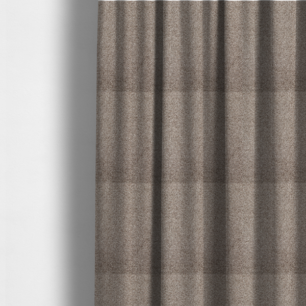 The fabric used to create these made-to-measure curtains is a swatch of taupe, heavily textured upholstery fabric.
