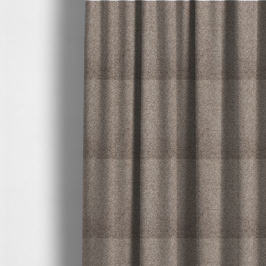 The fabric used to create these made-to-measure curtains is a swatch of taupe, heavily textured upholstery fabric.