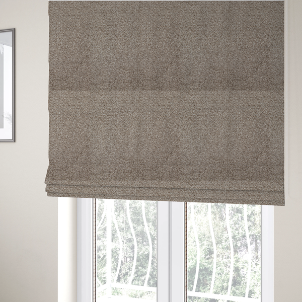 The fabric used to create these Roman blinds is a swatch of taupe, heavily textured upholstery fabric.