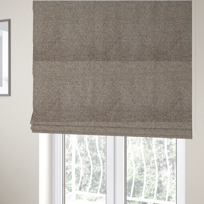 The fabric used to create these Roman blinds is a swatch of taupe, heavily textured upholstery fabric.