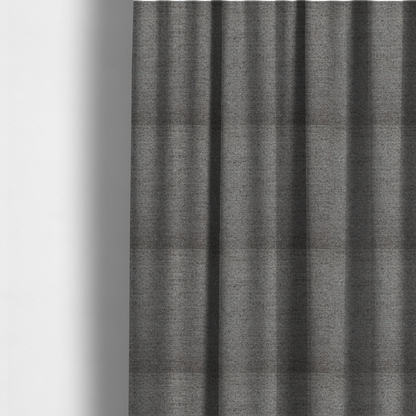 The fabric used to create these made-to-measure curtains is a dark grey, textured upholstery fabric.