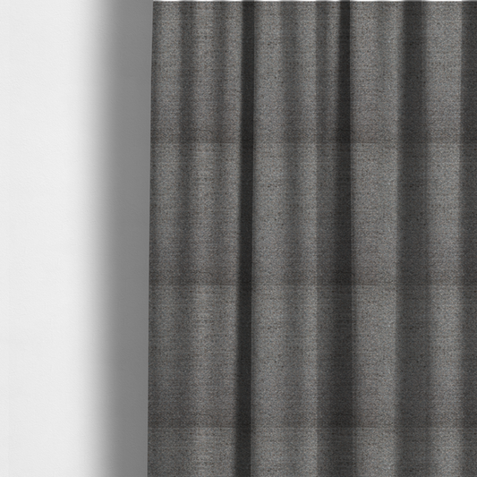 The fabric used to create these made-to-measure curtains is a dark grey, textured upholstery fabric.