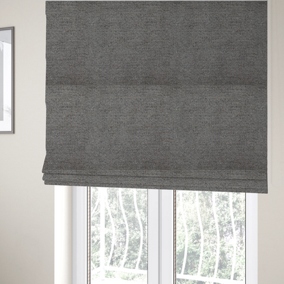 The fabric used to create these Roman blinds is a dark grey, textured upholstery fabric.